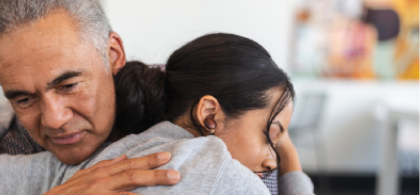 Older man hugging yourger woman